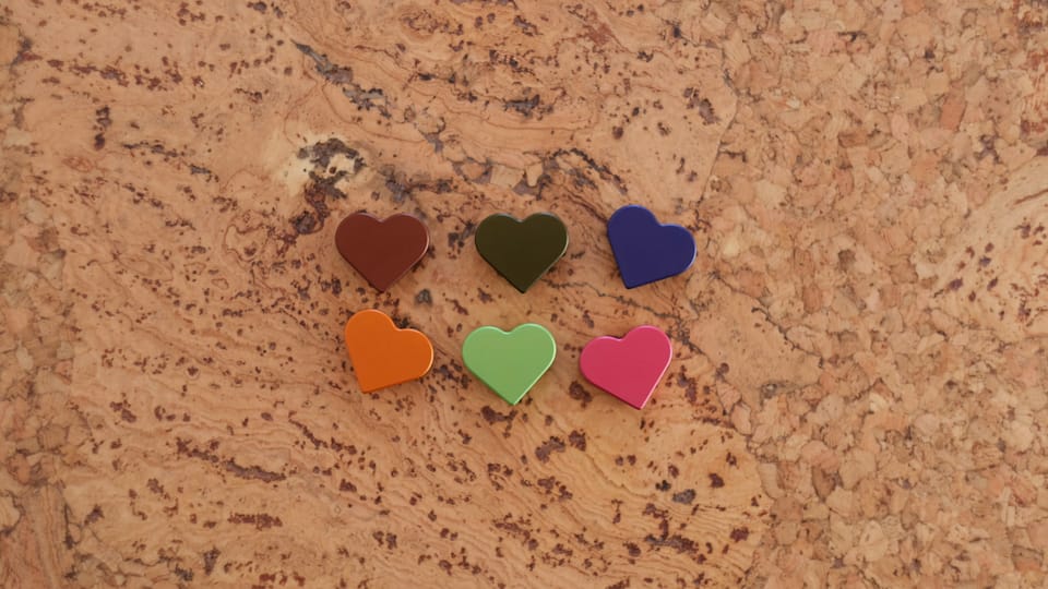 An image of 6 heart speed straddle cable hangers for bicycles. They are sitting on a cork surface.